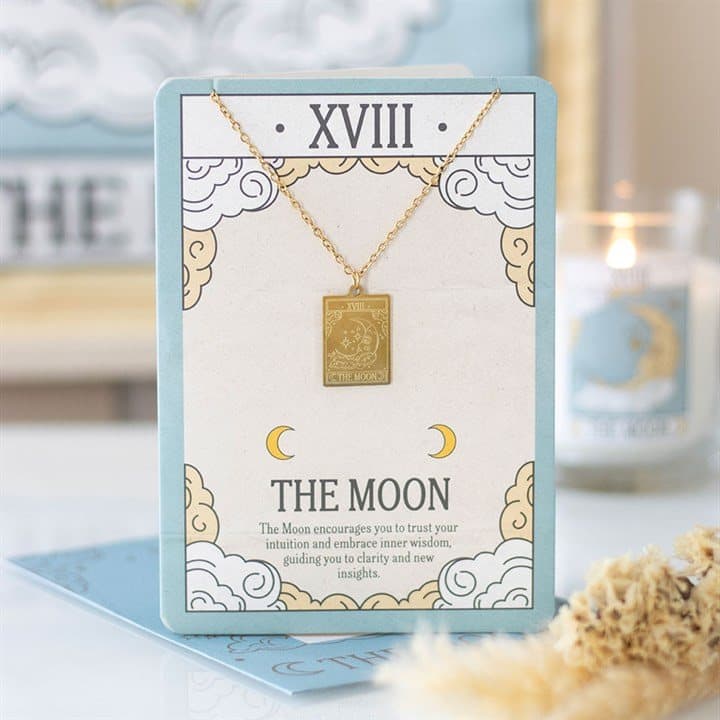 Gold-toned Moon tarot card pendant necklace on an illustrated greeting card