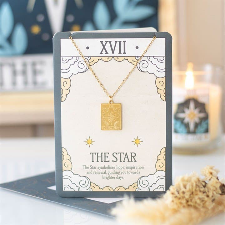 Gold-toned The Star tarot pendant necklace on a greeting card