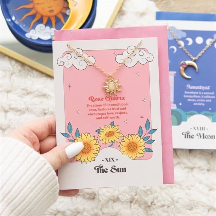 Sun pendant necklace with rose quartz on a colourful tarot-inspired card