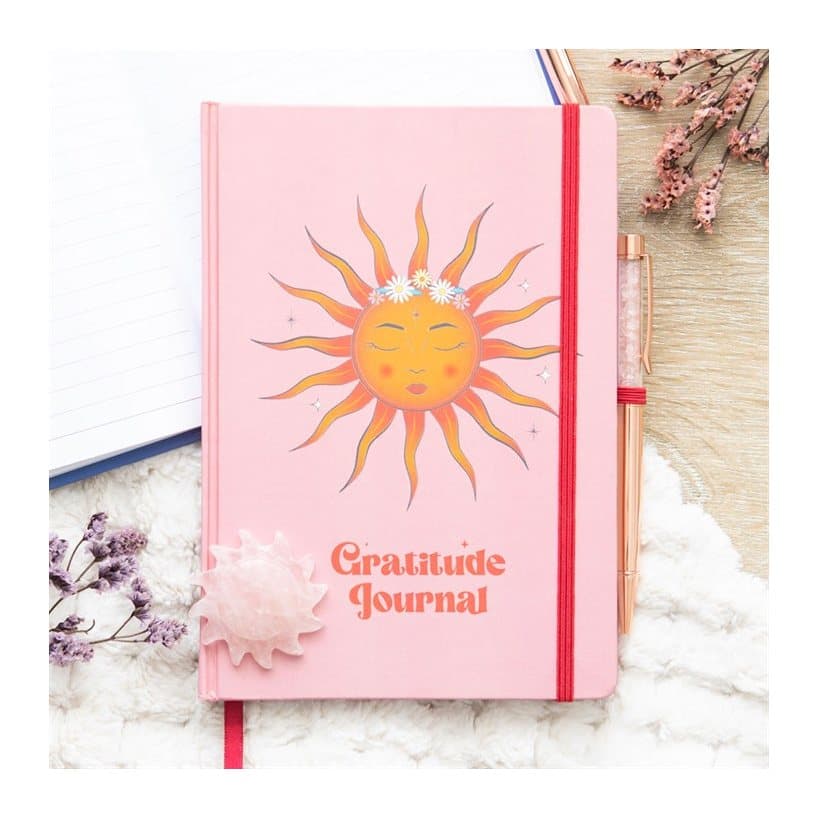 Gratitude journal with The Sun cover artwork and a rose quartz pen