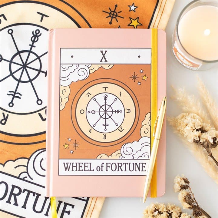 A5 notebook with a vintage The Wheel tarot card design on the cover