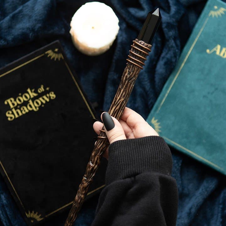 Slender crystal wand with a black obsidian crystal point