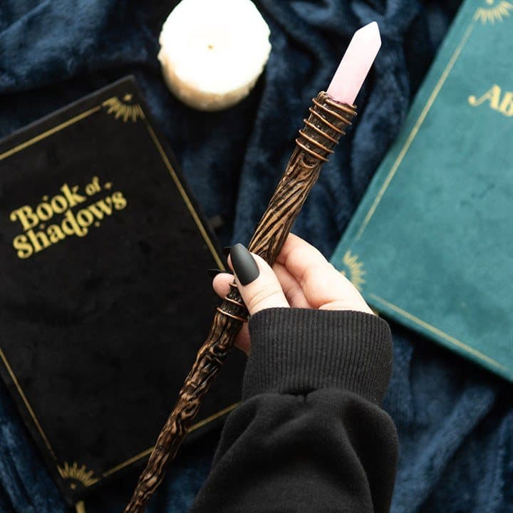 Thin wand with a pink rose quartz crystal point