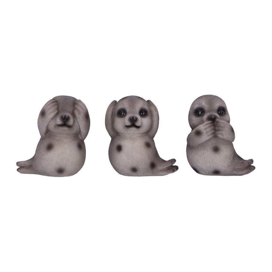 Three gray spotted resin seal figurines in see no evil, hear no evil, speak no evil poses