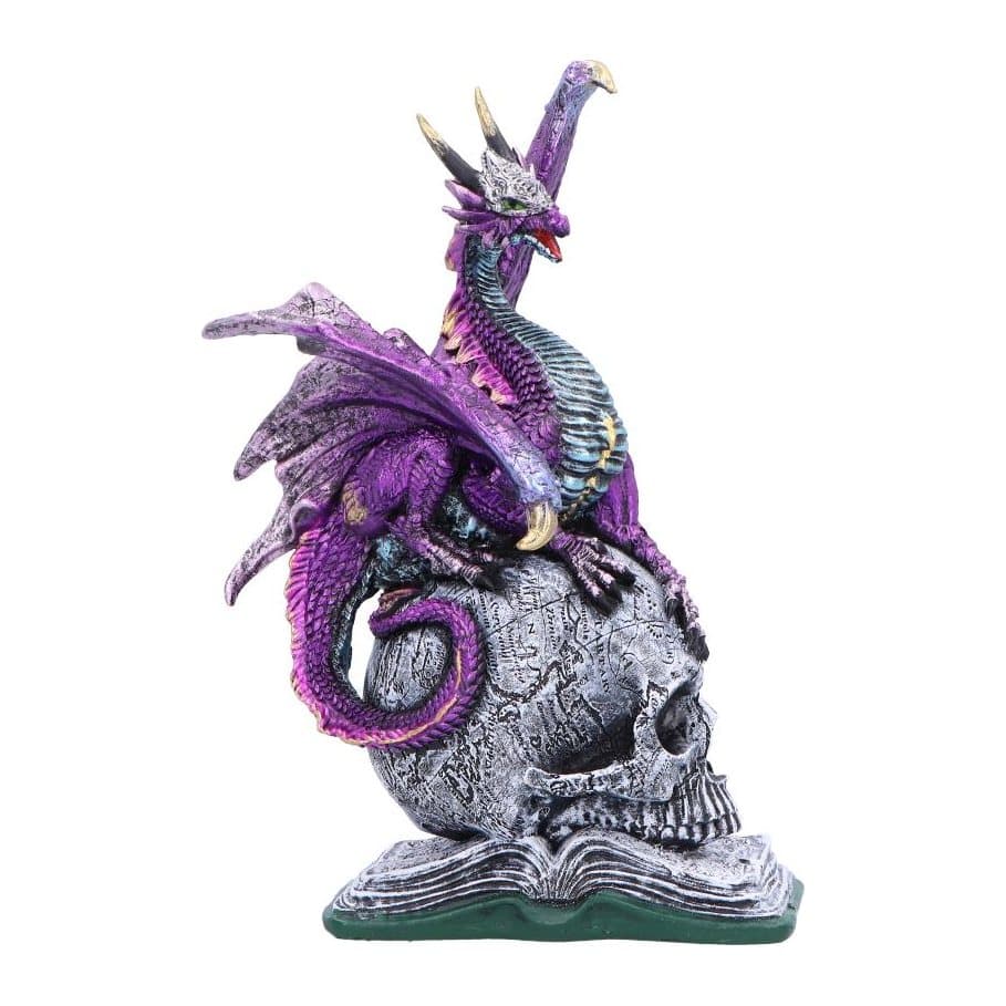 Purple and silver dragon figurine perched on a skull and book