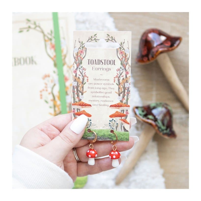 Toadstool mushroom dangle earrings hanging from small gold hoops