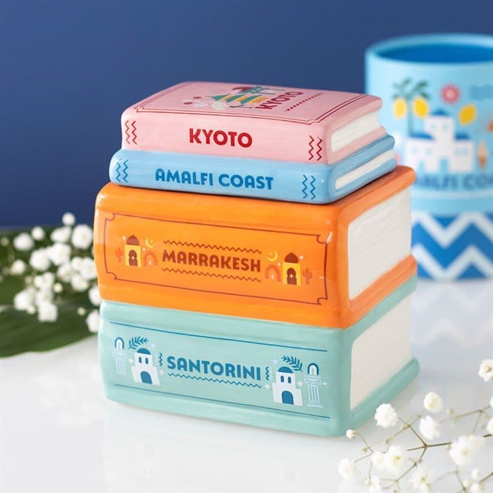 Colourful ceramic oil burner shaped like a stack of travel guide books