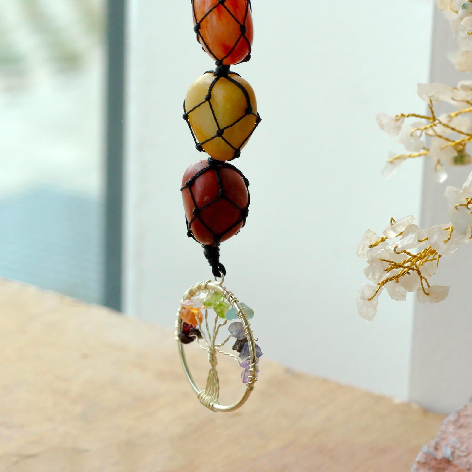 Hanging gemstone pendant with a tree of life design