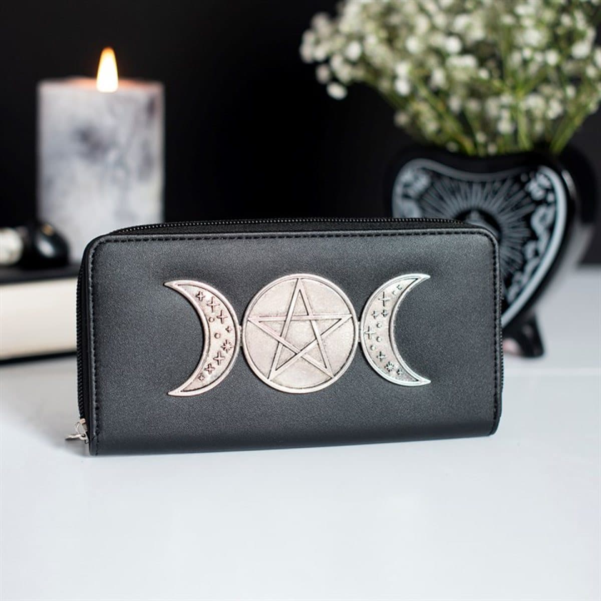 Black zippered wallet with a metallic triple moon and pentagram design