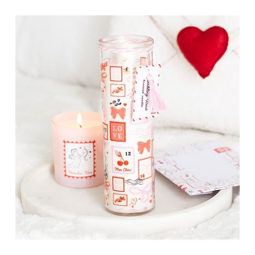 Postage stamp print tube candle in tall glass with pink tassel