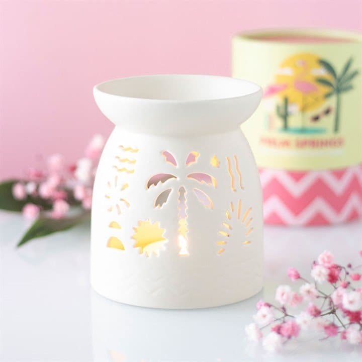White ceramic oil burner with cut-out palm and sunshine details