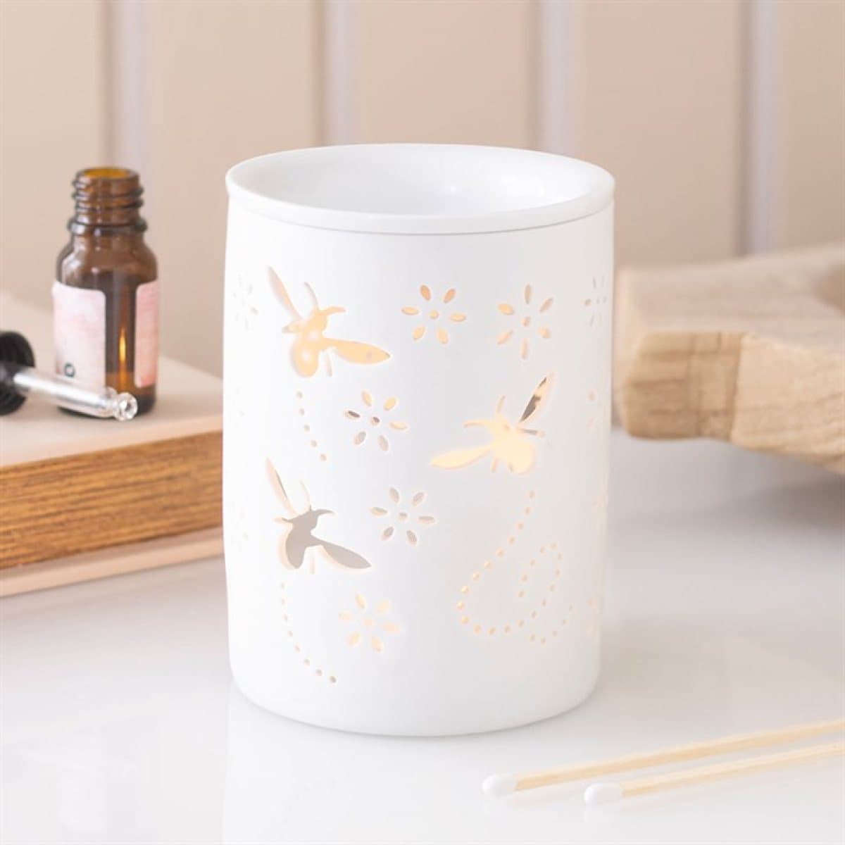 White ceramic oil burner and wax warmer with bee and flower cut outs