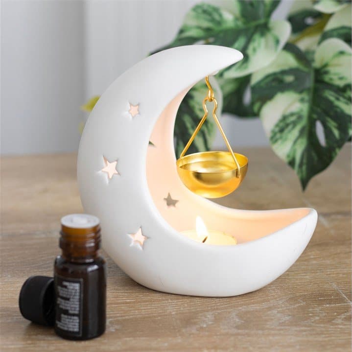 White ceramic crescent moon oil burner with gold dish and star cut-outs