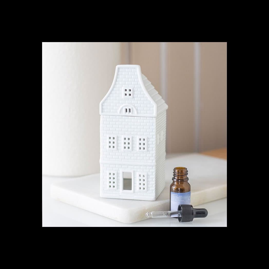 White ceramic oil burner shaped like a Nordic house