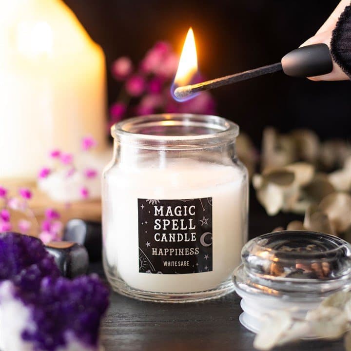 Small white jar candle in a glass jar with hang tag