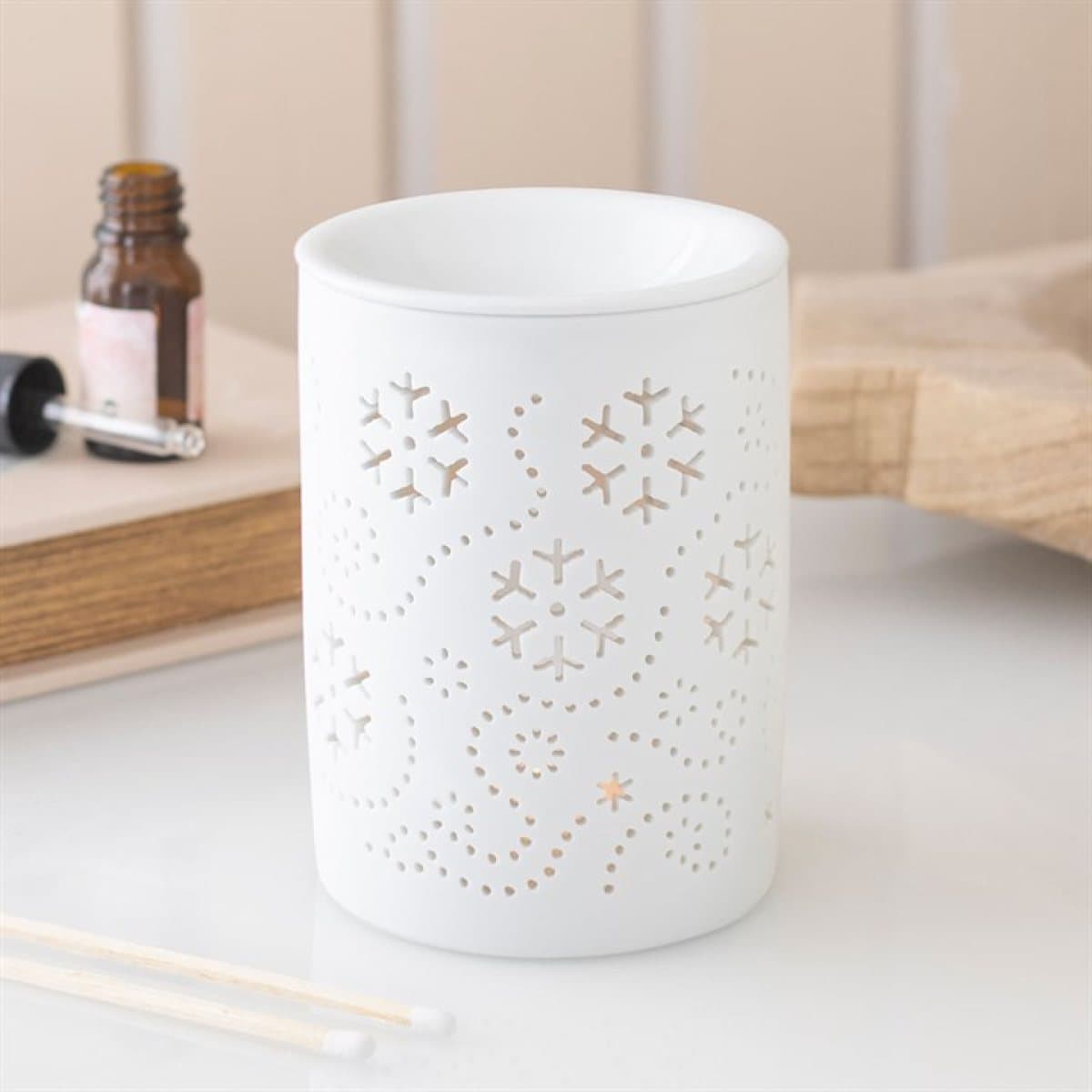 White ceramic oil burner and wax warmer with snowflake cut outs