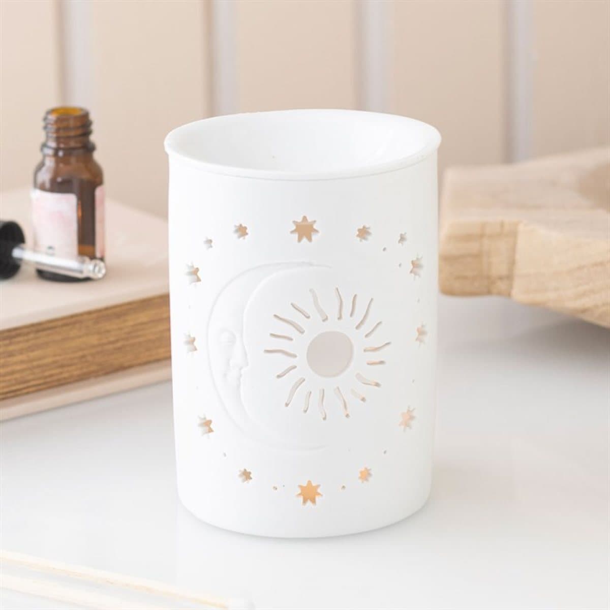 White ceramic oil burner and wax warmer with sun and moon cut outs