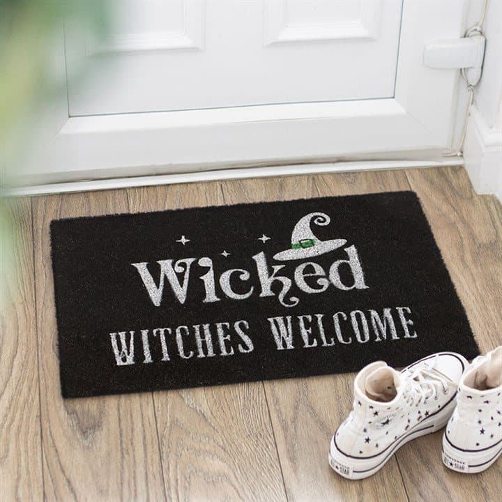Black coir doormat with witch hat design and welcome text