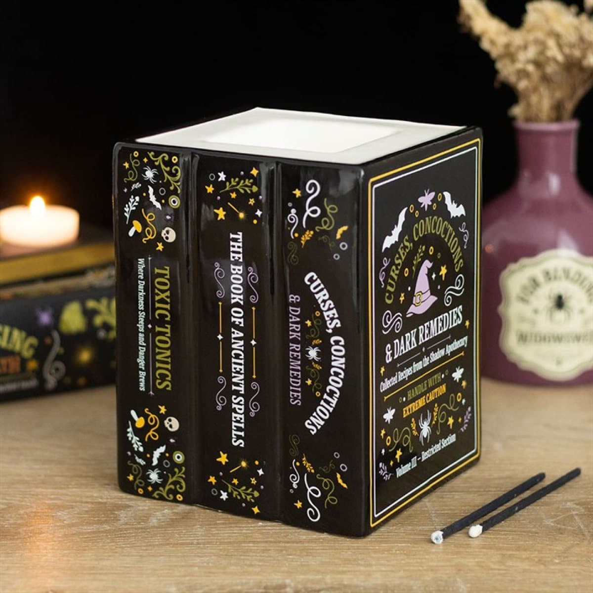Ceramic oil burner shaped like a stack of miniature spell books