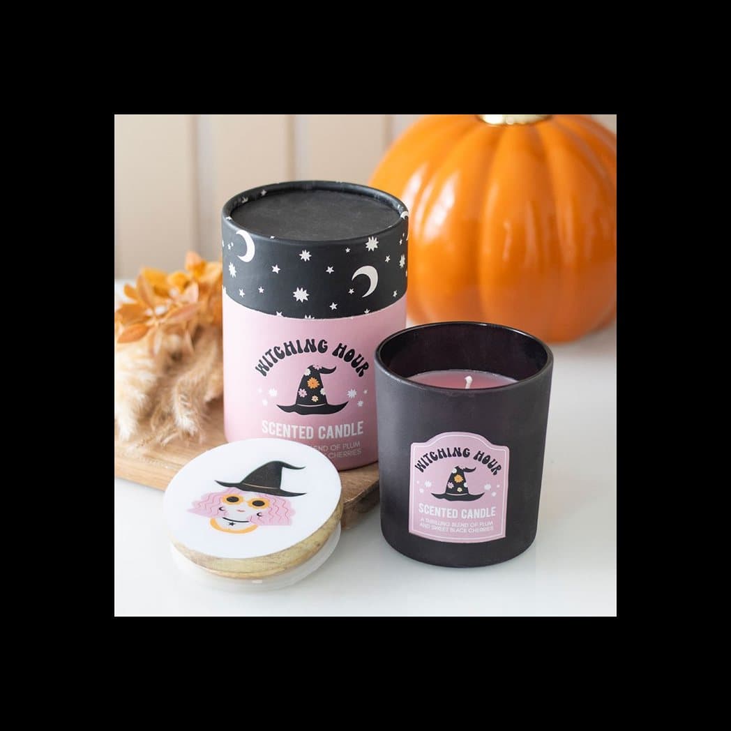 Plum and black cherry candle in a glass holder with a wooden witch-design lid