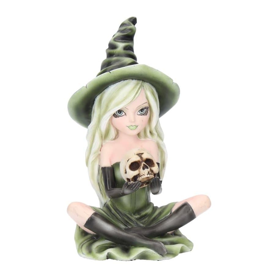 Zelda witch figurine in a green dress and hat sitting with a skull