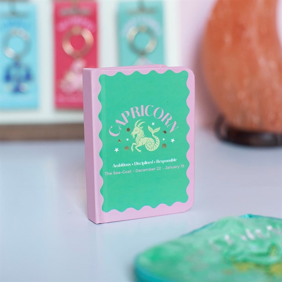 Mini A7 Capricorn notebook with a colourful sea-goat design